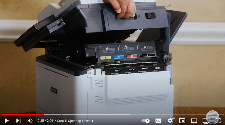 A printer technician opens the top cover on the Xerox C315 Color Multifunction Printer