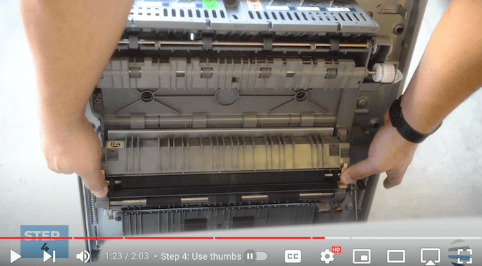Printer technician secures the new transfer roller on the Xerox AltaLink B8090