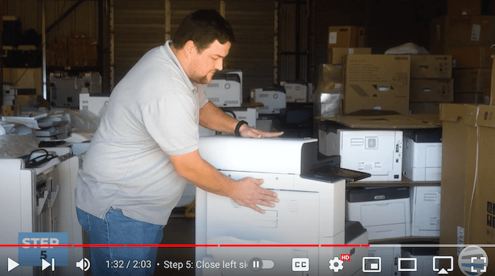 Printer technician closes the left side cover on the Xerox AltaLink B8090