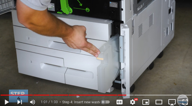 Printer technician inserts new waste toner container into Xerox PrimeLink C9065