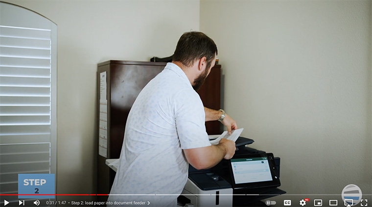 Xerox partner loads document into his Xerox printer