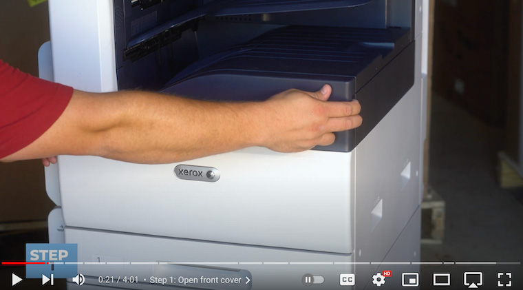 Printer technician opens the front cover on the Xerox VersaLink C7020/C7025/C7030 Printer