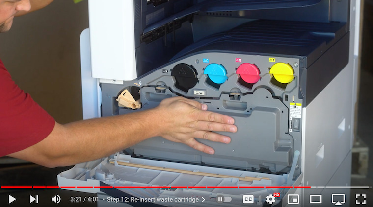 Printer technician re-inserts waste cartridge on the Xerox VersaLink C7020/C7025/C7030