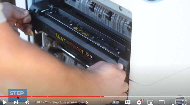 Printer technician inserts the new fuser on a Xerox AltaLink B8090 Printer
