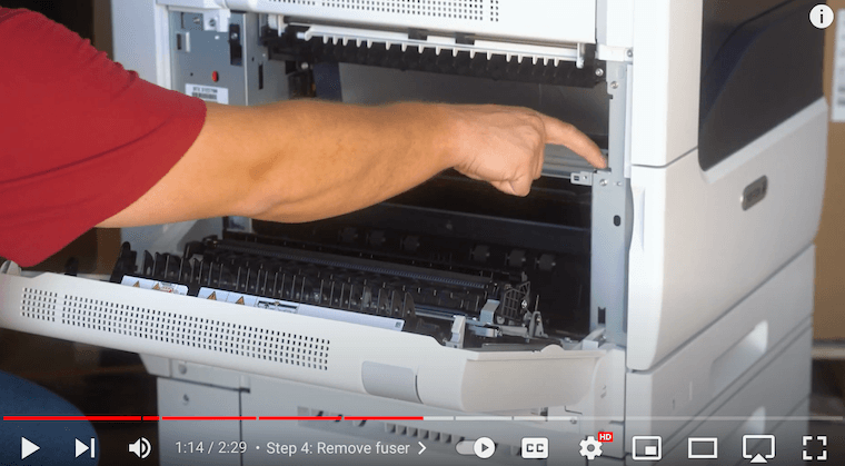 Printer technician inserts the new fuser on the metal areas of the Xerox VersaLink C7020/C7025/C7030 Printer
