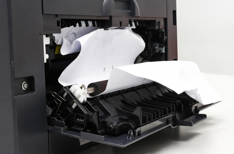 A paper jam on a black printer