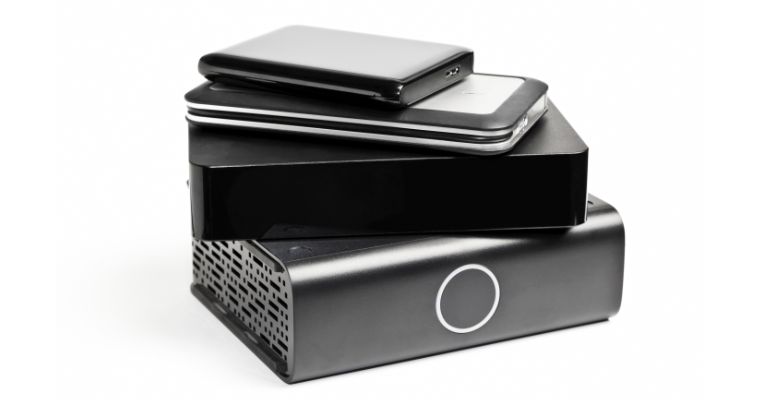 Stack of external hard drives on white background